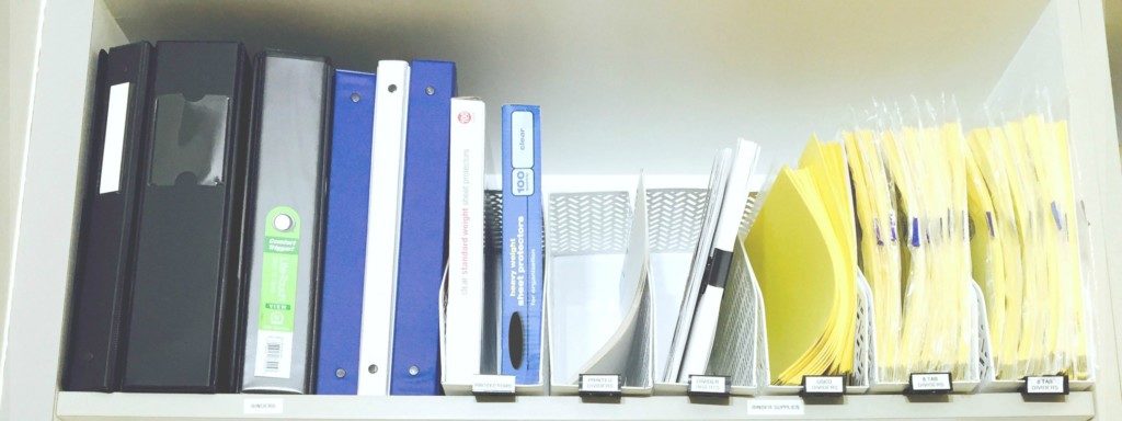 organized binder supplies in mailroom